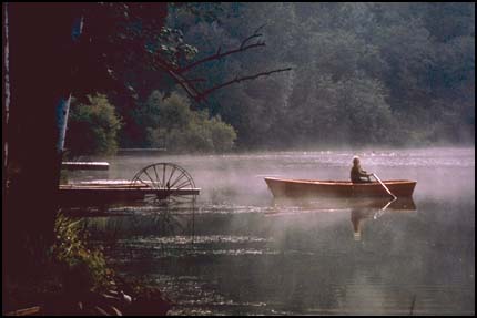 Man in rowboat on lake