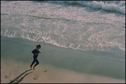 2nd view of figure running on beach